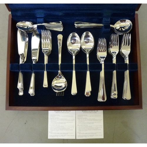 242 - A Marks & Spencer stainless steel, eight place setting canteen of cutlery, in a fitted mahogany ... 
