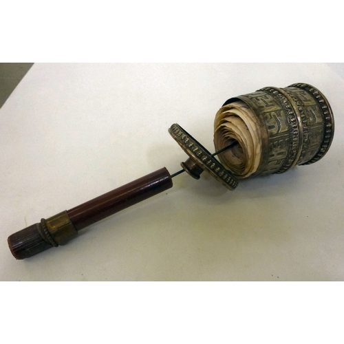 5 - A white metal Tibetan Buddhist prayer wheel, on a turned wooden handle