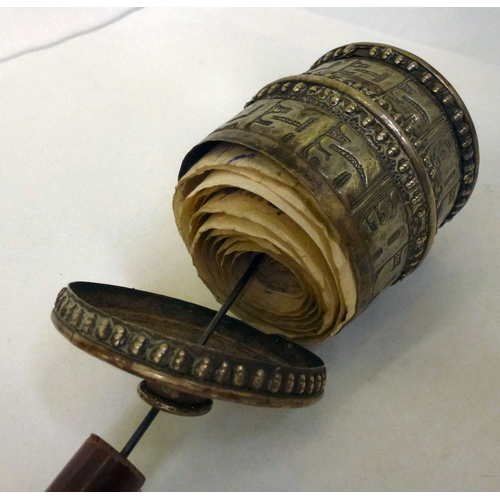 5 - A white metal Tibetan Buddhist prayer wheel, on a turned wooden handle