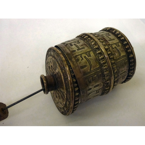 5 - A white metal Tibetan Buddhist prayer wheel, on a turned wooden handle