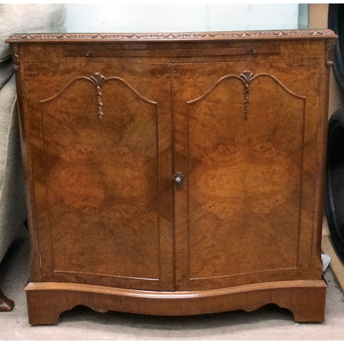 56 - A modern walnut finished serpentine front side cabinet with two doors, raised on bracket feet&nbsp; ... 