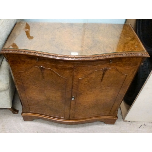 56 - A modern walnut finished serpentine front side cabinet with two doors, raised on bracket feet&nbsp; ... 