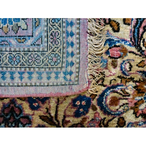 58 - A Persian part-silk rug, decorated with dense flora, on a maroon ground  80