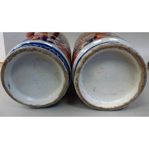 11 - A pair of Japanese Imari vases, decorated with flora&nbsp; each 13