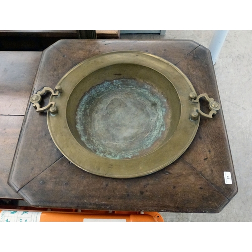 17 - A mid 19thC brazier table, the brass bowl with two handles and an oak frame with canted corners and ... 