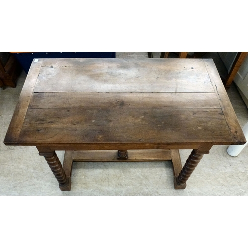 18 - A mid 19thC oak farmhouse style side table, the planked top over two opposing drawers, raised on bob... 