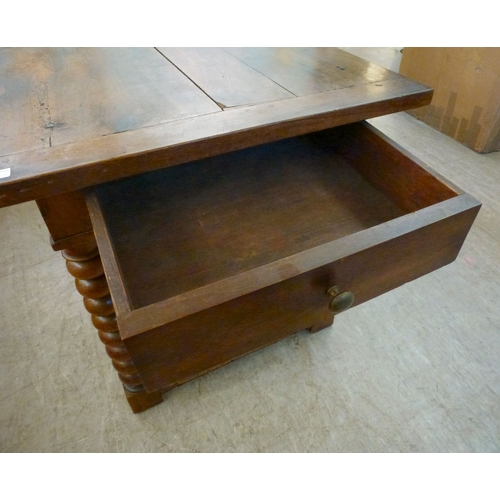 18 - A mid 19thC oak farmhouse style side table, the planked top over two opposing drawers, raised on bob... 