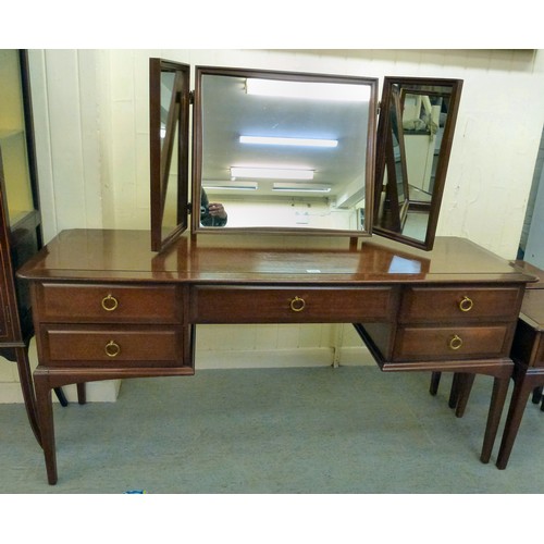 300 - A Stag mahogany dressing table with a raised, mirrored back, over five drawers, raised on square leg... 