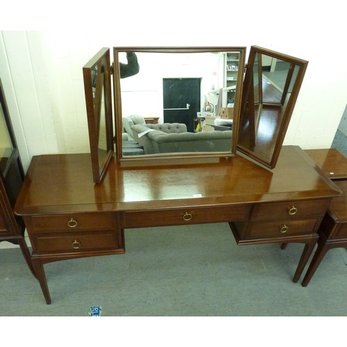 300 - A Stag mahogany dressing table with a raised, mirrored back, over five drawers, raised on square leg... 
