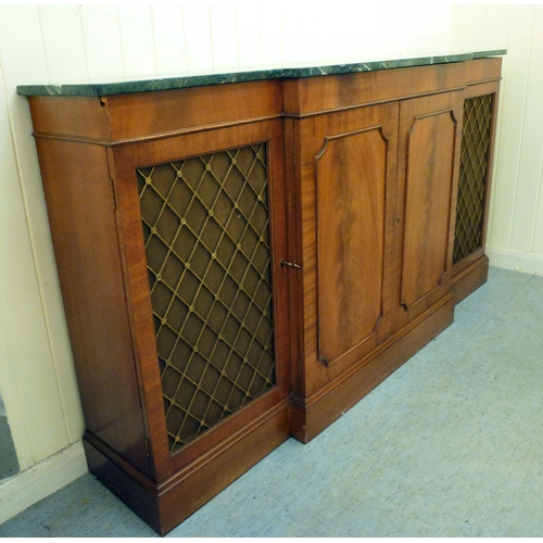 107 - A modern Reprodux mahogany breakfront chiffonier, the marble top over four doors, raised on a plinth... 