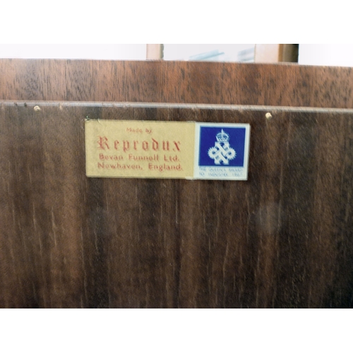 107 - A modern Reprodux mahogany breakfront chiffonier, the marble top over four doors, raised on a plinth... 