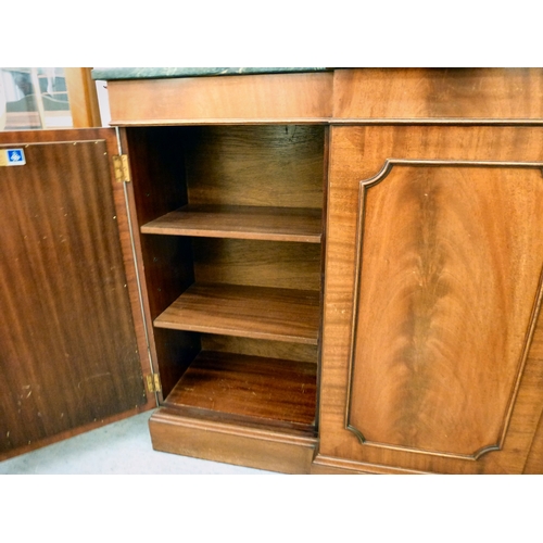 107 - A modern Reprodux mahogany breakfront chiffonier, the marble top over four doors, raised on a plinth... 