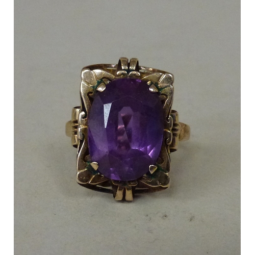 12 - A 14ct gold ring, set with an amethyst coloured stone&nbsp; (approx. 7.6grms)