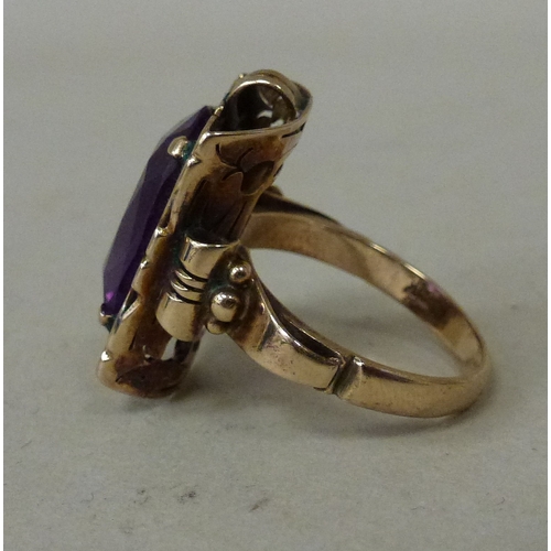 12 - A 14ct gold ring, set with an amethyst coloured stone&nbsp; (approx. 7.6grms)