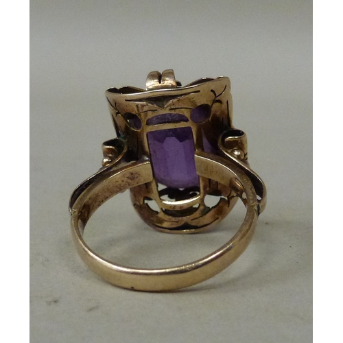 12 - A 14ct gold ring, set with an amethyst coloured stone&nbsp; (approx. 7.6grms)