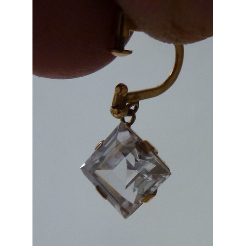 14 - A pair of 18ct gold earrings, each set with white stones