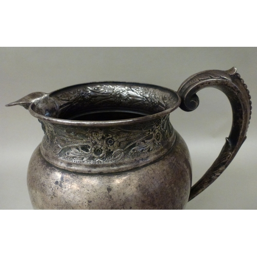 21 - WITHDRAWN A white metal jug of sparrow beak design  7.5