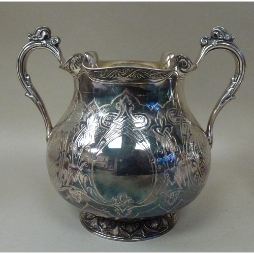 3 - A mid Victorian silver three piece tea set, comprising a teapot, sugar basin and milk jug with scrol... 