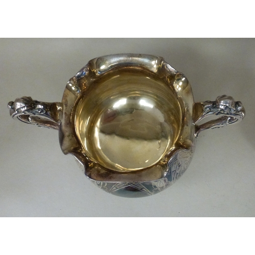 3 - A mid Victorian silver three piece tea set, comprising a teapot, sugar basin and milk jug with scrol... 