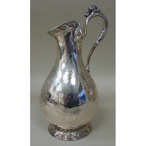 3 - A mid Victorian silver three piece tea set, comprising a teapot, sugar basin and milk jug with scrol... 