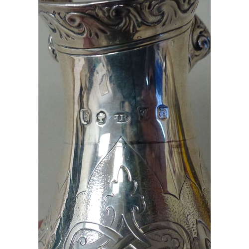 3 - A mid Victorian silver three piece tea set, comprising a teapot, sugar basin and milk jug with scrol... 