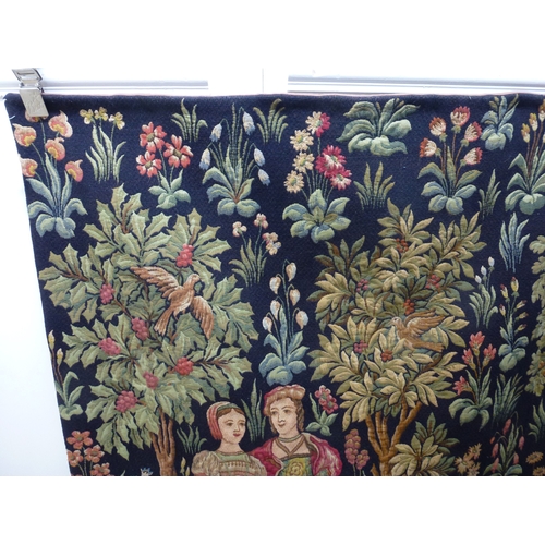 55 - HAL - a 20thC Flemish inspired tapestry hanging, depicting figures in period costume, in a woodland ... 