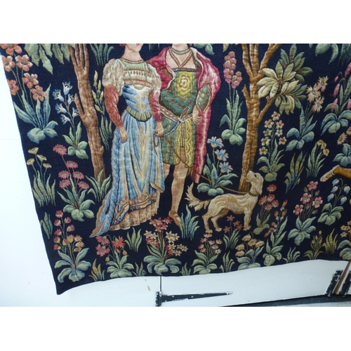 55 - HAL - a 20thC Flemish inspired tapestry hanging, depicting figures in period costume, in a woodland ... 
