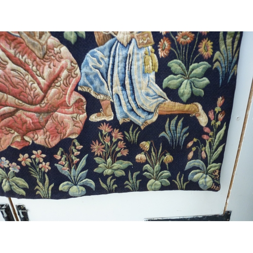 55 - HAL - a 20thC Flemish inspired tapestry hanging, depicting figures in period costume, in a woodland ... 