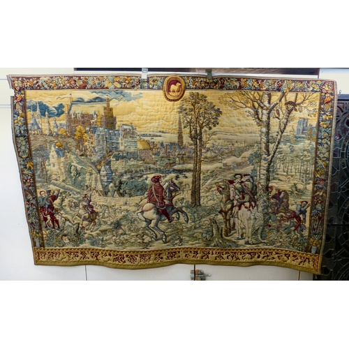 57 - A 20thC Flemish inspired tapestry hanging, depicting an inner city landscape from a woodland hillsid... 