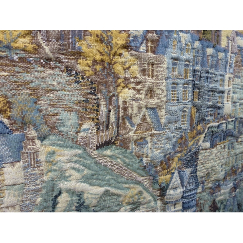 57 - A 20thC Flemish inspired tapestry hanging, depicting an inner city landscape from a woodland hillsid... 