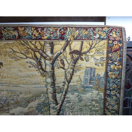 57 - A 20thC Flemish inspired tapestry hanging, depicting an inner city landscape from a woodland hillsid... 