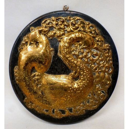 11 - An Arts & Crafts period worked and pressed brass plaque of a swan. amongst C-scroll and foliage,... 