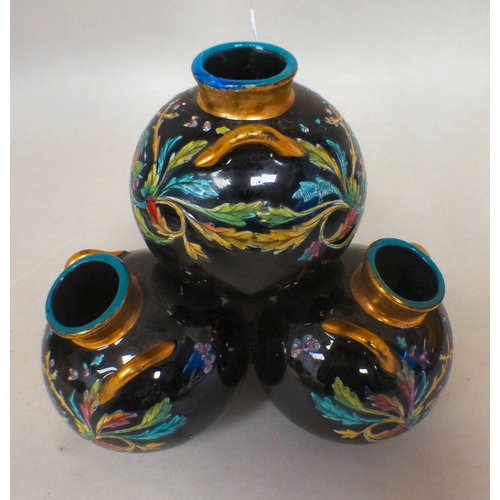 19 - A late Victorian glass centrepiece comprising four stacked, twin handled vases with gilding and flor... 