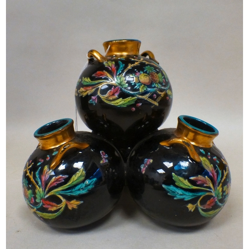 19 - A late Victorian glass centrepiece comprising four stacked, twin handled vases with gilding and flor... 