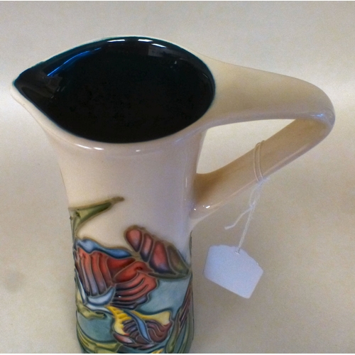 27 - A Moorcroft pottery Iris pattern jug  bears printed marks  dated '96  9.5