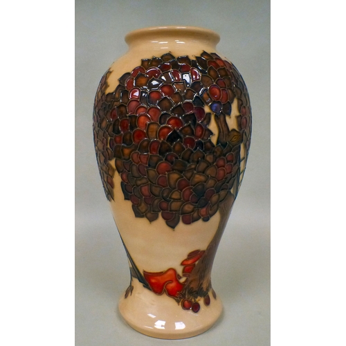 31 - A Moorcroft pottery Apple Tree pattern vase bears printed marks  dated '97  10.5