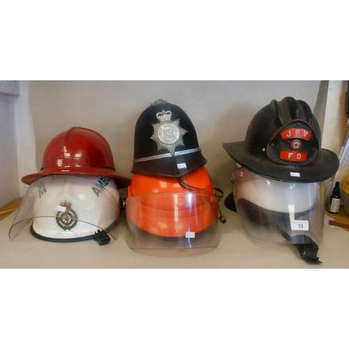 33 - Six Emergency services helmets: to include UK and American examples(Please Note: this lot is subject... 