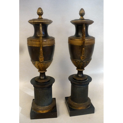 37 - A pair of late 19thC Empire design cast metal, urn design vases/candlesticks, on a plinth  14.5