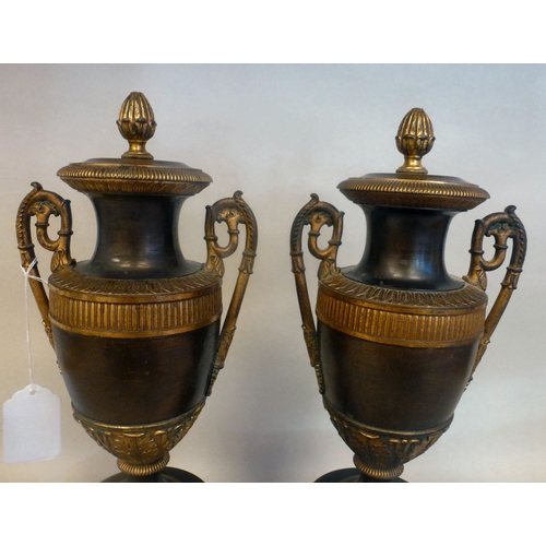 37 - A pair of late 19thC Empire design cast metal, urn design vases/candlesticks, on a plinth  14.5