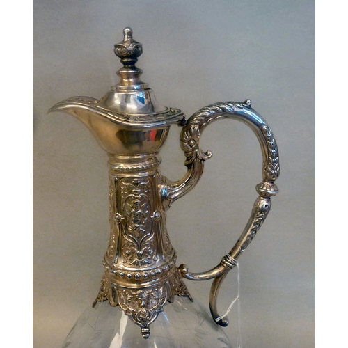 44 - A mid 20thC glass and silver plated claret jug, embossed with cherubs and swags&nbsp; 14