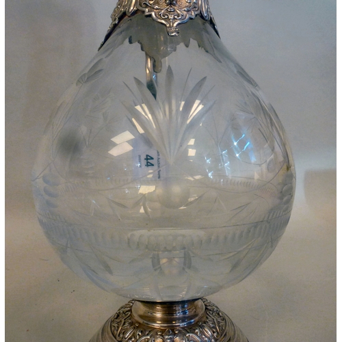44 - A mid 20thC glass and silver plated claret jug, embossed with cherubs and swags&nbsp; 14