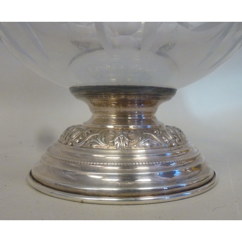 44 - A mid 20thC glass and silver plated claret jug, embossed with cherubs and swags&nbsp; 14