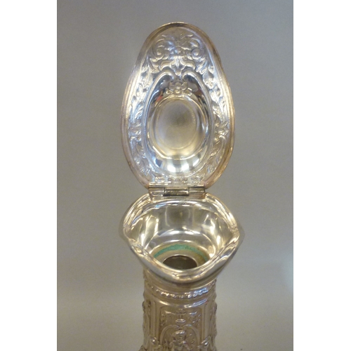 44 - A mid 20thC glass and silver plated claret jug, embossed with cherubs and swags&nbsp; 14