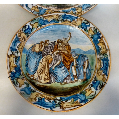 47 - A pair of late 19thC Italian Majolica chargers, each decorated with figures&nbsp; 17