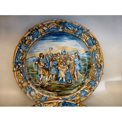 47 - A pair of late 19thC Italian Majolica chargers, each decorated with figures&nbsp; 17