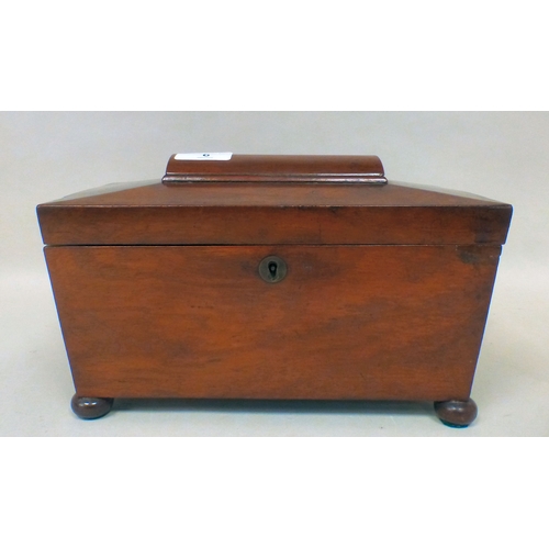6 - A late Regency mahogany tea caddy of sarcophagus form, the hinged lid enclosing two lidded compartme... 