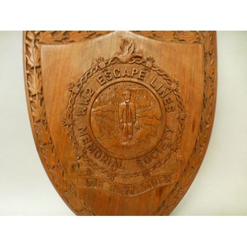 8 - A mid 20thC shield shaped fruitwood plaque, inscribed 'World War II Escape Lines Memorial Society' a... 