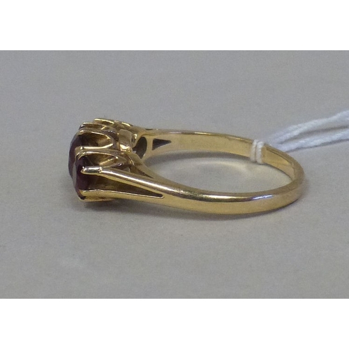 14 - A 9ct gold ring, set with three red stones&nbsp; (approx. 2.8grm)