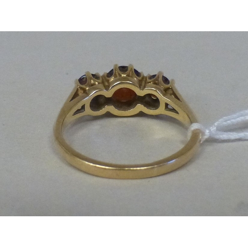 14 - A 9ct gold ring, set with three red stones&nbsp; (approx. 2.8grm)