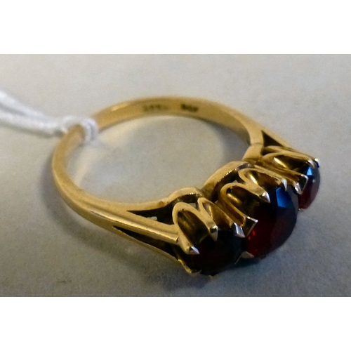 14 - A 9ct gold ring, set with three red stones&nbsp; (approx. 2.8grm)